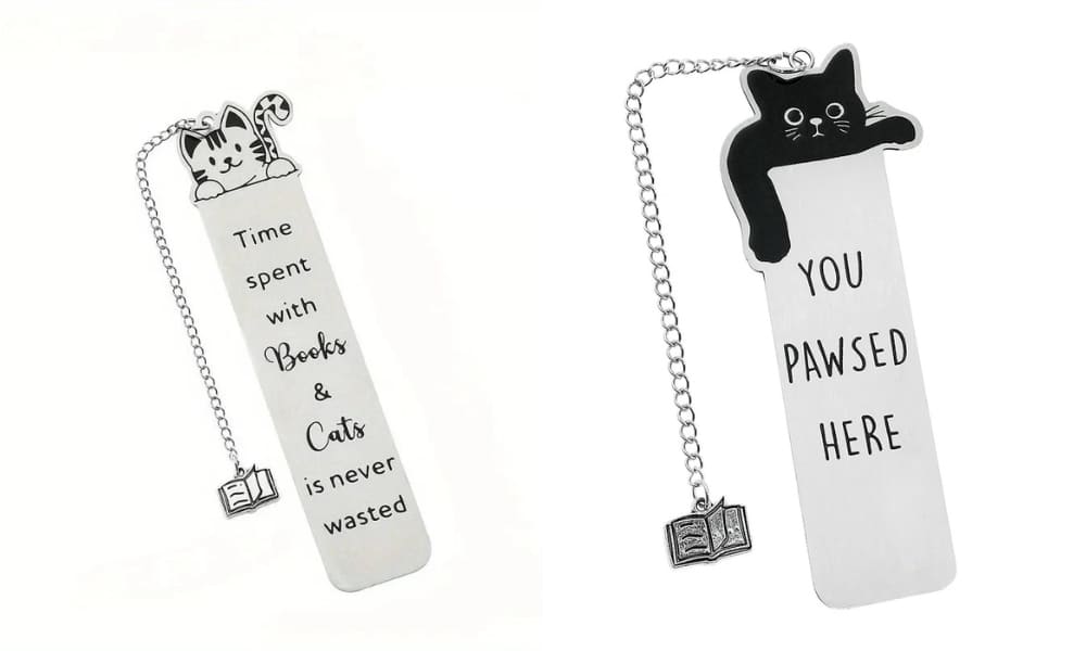 A silver metal bookmark featuring a cute tabby cat illustration and the engraved quote 'Time spent with Books & Cats is never wasted.' The bookmark includes a silver chain with a small open book charm, isolated on a white background.