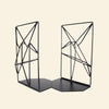 Pair of black geometric bookends on a beige background