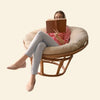Beige cushioned papasan chair with a woven wicker frame.