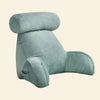 A plush, light teal velvet reading chair pillow with a rounded headrest and built-in side support.